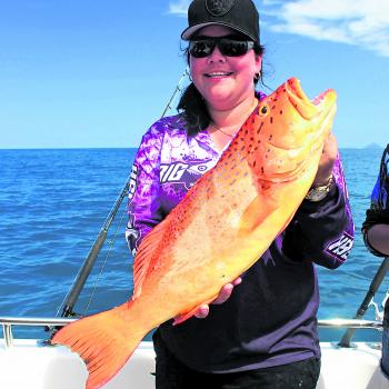 Kyahne Smail with a barred-cheek coral trout – beautiful to eat and beautiful look at.
