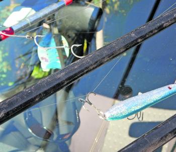 The tackle on your rods needs to be secured so that it doesn’t come loose where it can fly around and damage someone. A large sinker could easily smash a windscreen, dent your vehicle or damage the blank of a rod if it came free. My advice would be to unr